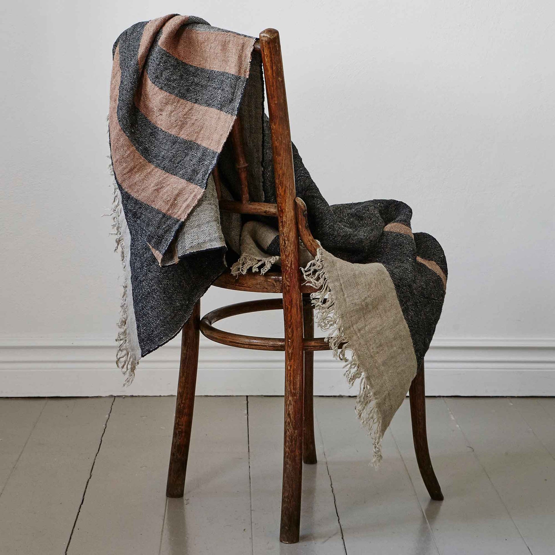 Belgian linen fouta throw blanket lifestyle product shot in color Black Stripe by Libeco for South Hous.
