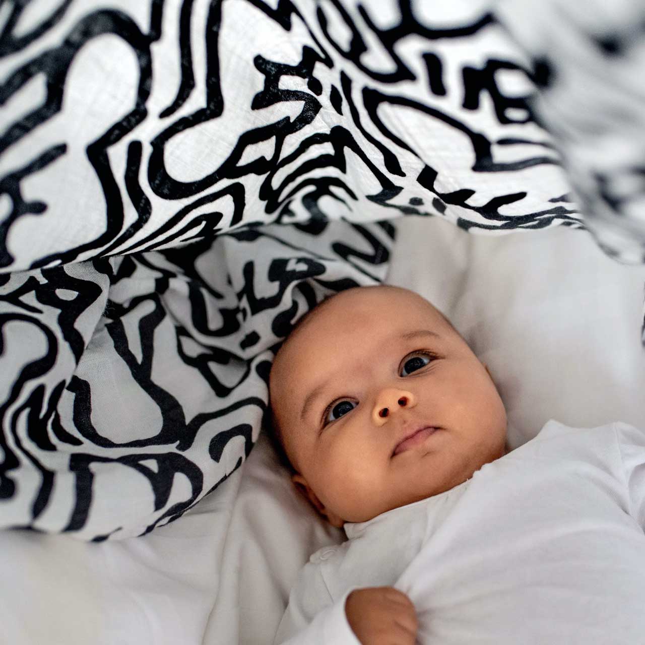 Keith Haring Pop Art Print Muslin Squares blanket lovey lifestyle product shot in color Black & White by Etta Loves for South Hous.