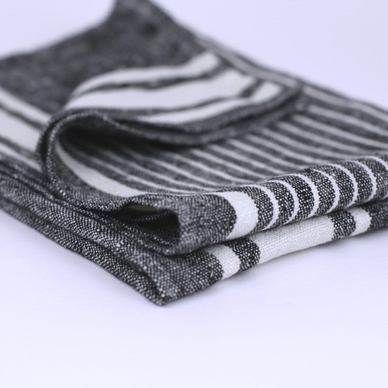 Linen Kitchen Towel angle lay fold edge detail product shot in color Black with White Stripe by LinenCasa for South Hous.