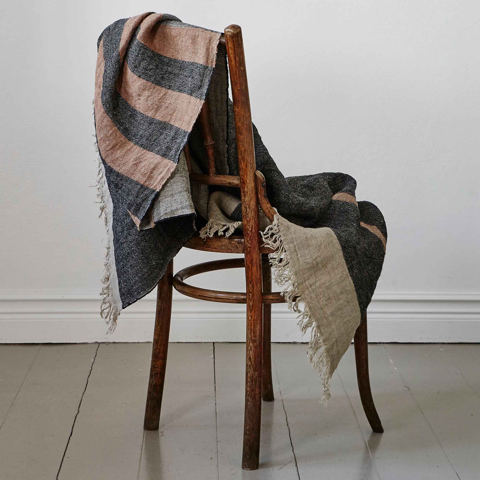 Belgian linen fouta throw blanket lifestyle product shot in color Black Stripe by Libeco for South Hous.