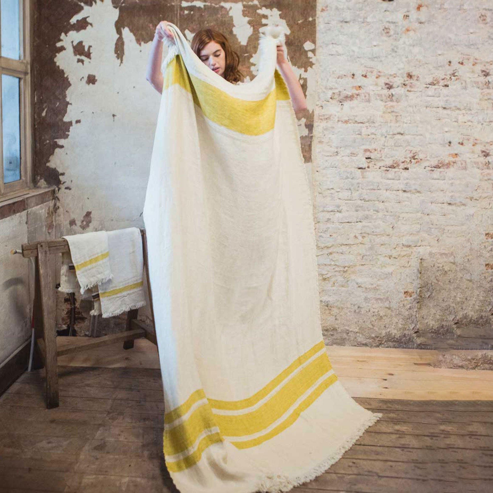 Belgian linen fouta throw blanket lifestyle product shot in color Mustard Stripe by Libeco for South Hous.