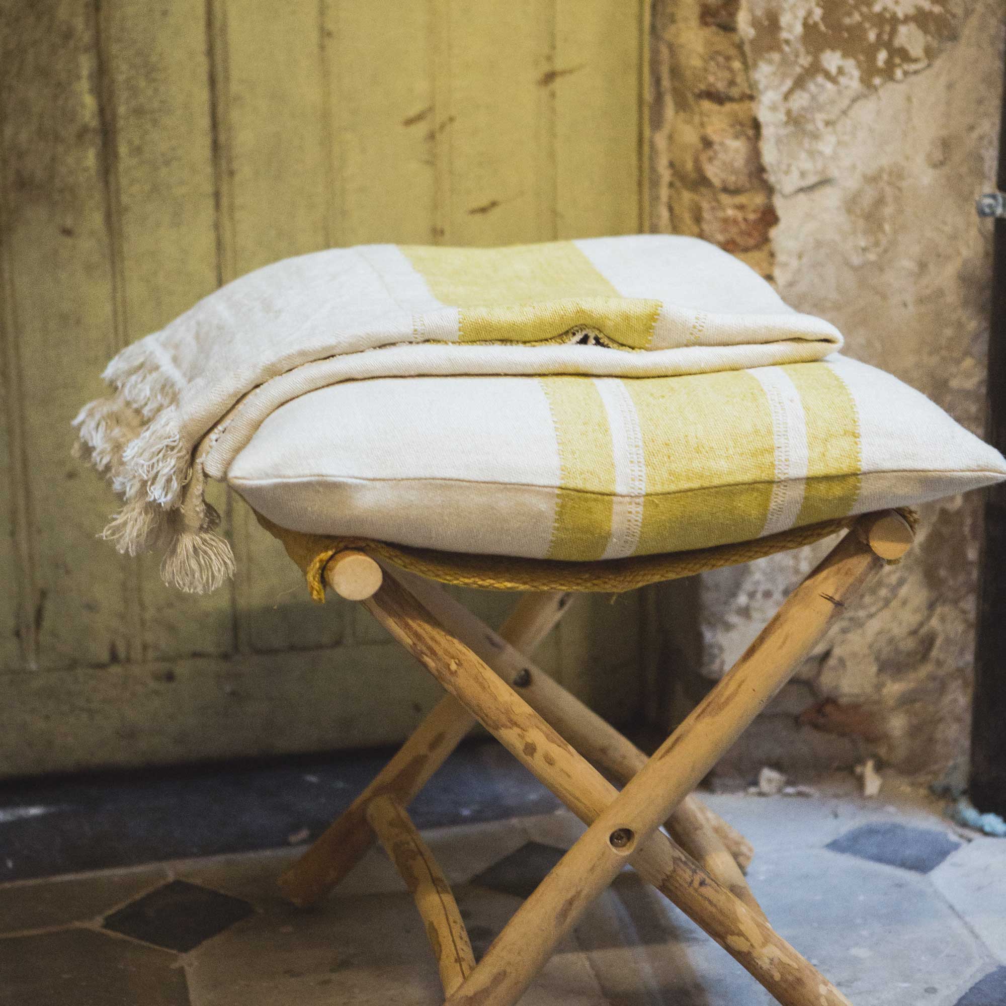 Belgian linen throw blanket and pillow cover set stack in color Mustard Stripe by Libeco for South Hous.