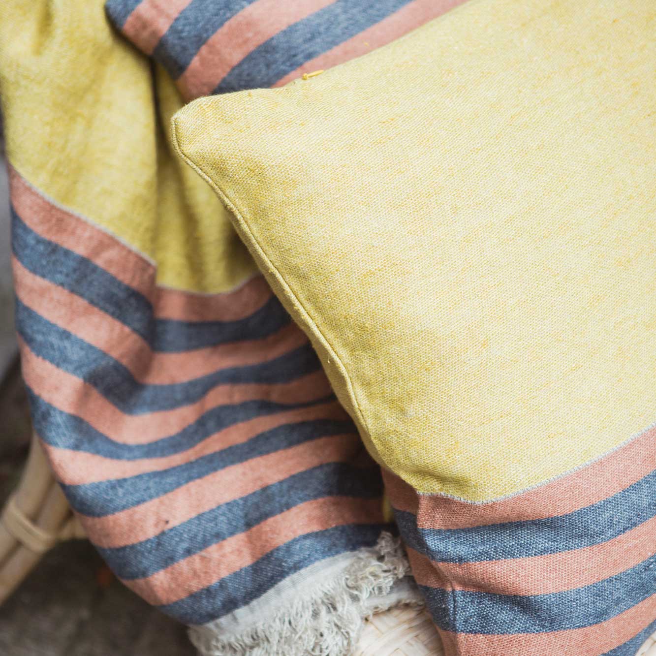 Belgian linen throw blanket and pillow cover set closeup shot in color Red Earth by Libeco for South Hous.