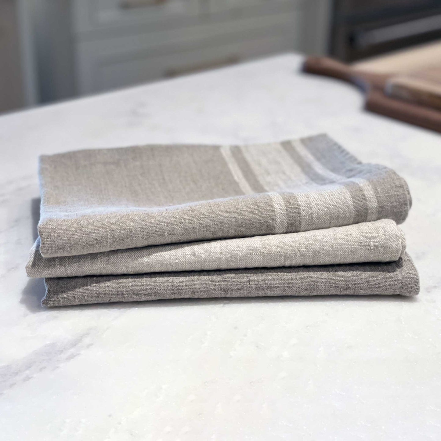 Linen Kitchen Towel lifestyle flat lay product stack shot in color Natural by LinenCasa for South Hous.