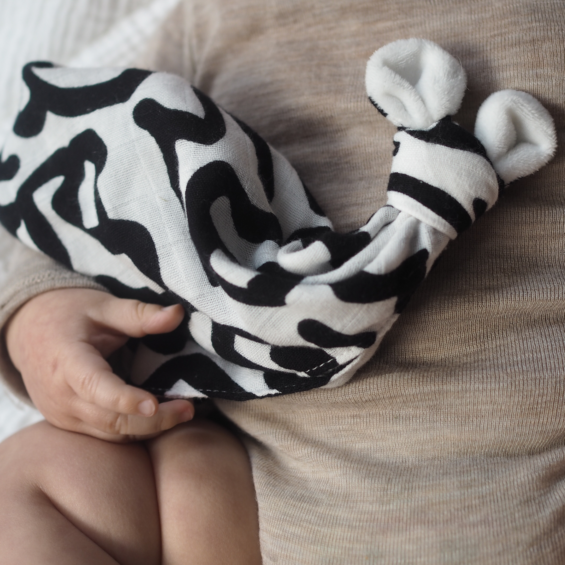 Keith Haring Print Baby Lovey lifestyle detail product shot in color black and white by Etta Loves for South Hous.